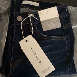 Pink Lily dark washed distressed skinny jeans.